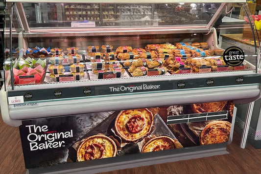 Café display with neatly arranged pastries attracting customer attention