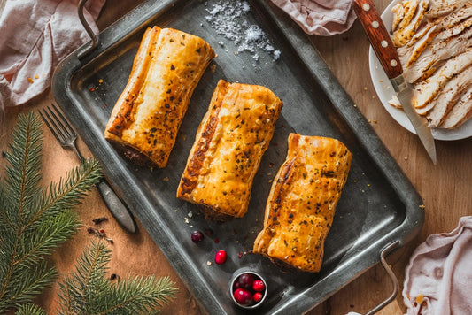 Festive limited-edition sausage rolls displayed in a bakery for holiday sale