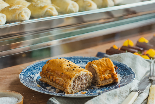 Freshly baked pies displayed on a café counter for customers.