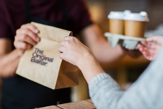 Café counter displaying enticing pies and sausage rolls for upselling meal deals