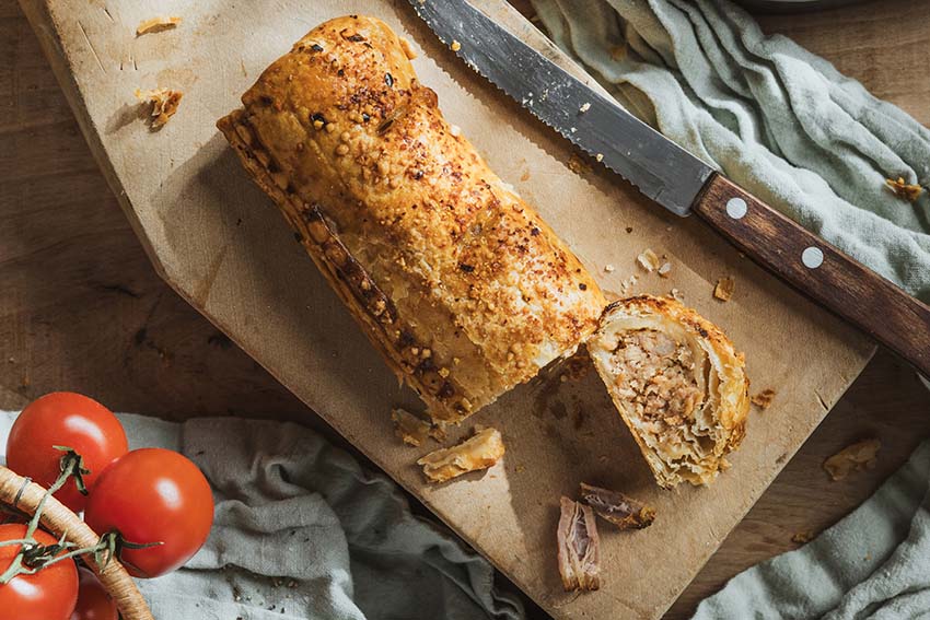 BBQ Pulled Pork Sausage Roll cut open showing pulled pork in BBQ sauce