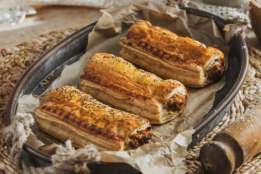 Three Bacon & Mature Cheddar Sausage Roll in light, flaky pastry