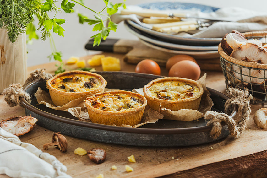 Three Bacon & Mushroom Quiches in golden all-butter pastry on a serving plate