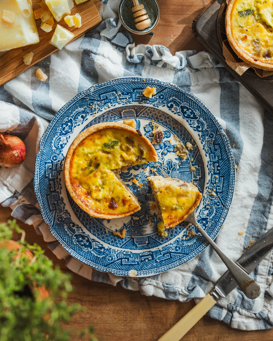 Slice of Cheese & Onion Quiche showing cheddar and onion filling